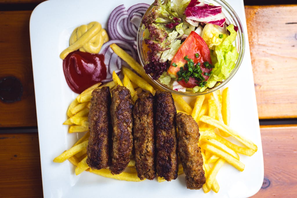 cevapi in Sarajevo served with somun bread and onion